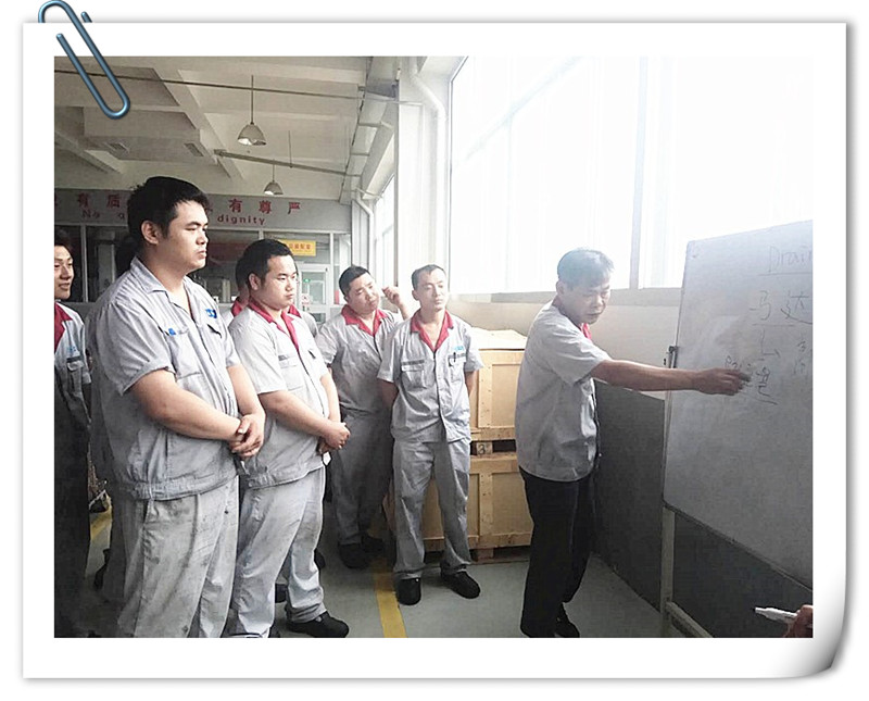 Foreign  production director carries out education instruction to employees.